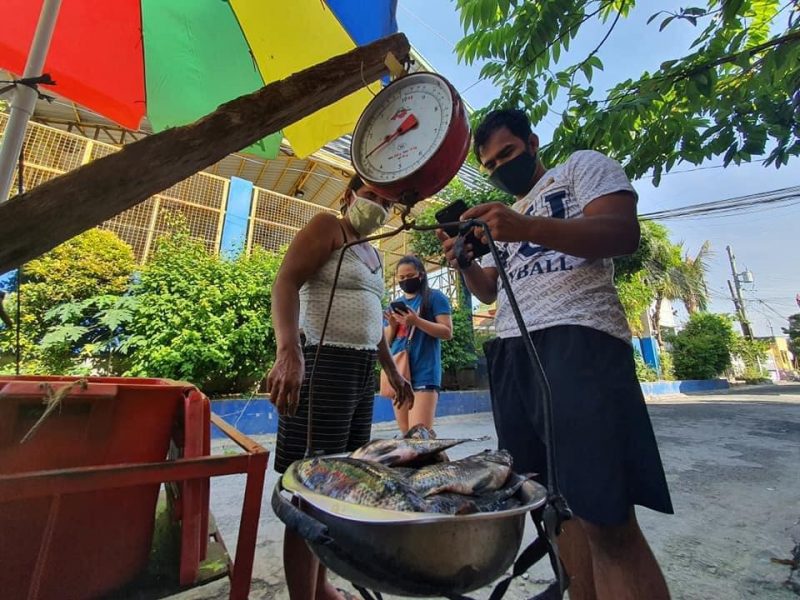 Ricky Marcos, an Filipino athlete-turned-entrepreneur during the pandemic, sells fish to earn money for family